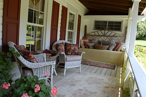 Chairs and a Daybed offer ample room to relax on the wrap-around porch.