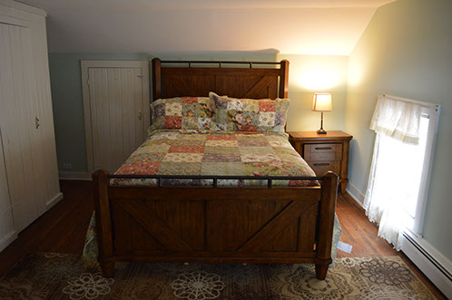 A large queen bed is perfect in this rental near Mohican state park.