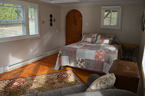 A bed, sofa and TV is available in the guest cottage rental.